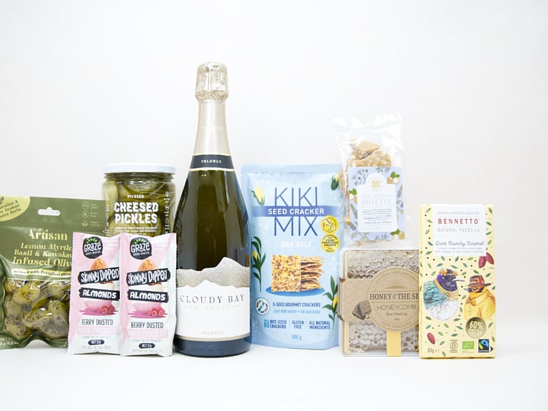 Congratulations Gift Box featuring Cloudy Bay Pelorus sparkling wine, artisan olives, pickled cucumbers, Kiki Seed Crackers, Sesh honey, Bennetto salted caramel chocolate, Skinny Dipped almonds, and macadamia brittle superseeds, beautifully packaged for celebrations and milestone gifting.