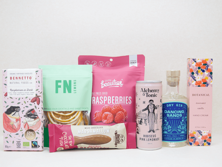 The Perfect G&T Gift Box featuring Dancing Sands Gin, Alchemy & Tonic Lemonade, Little Beauties freeze-dried raspberries, FN citrus garnishes, Botanicals Rosewater & Vanilla hand cream, Bennetto chocolate, and Potter Brothers chocolate fish, beautifully packaged for gin lovers and gifting.