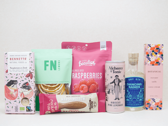 The Perfect G&T Gift Box featuring Dancing Sands Gin, Alchemy & Tonic Lemonade, Little Beauties freeze-dried raspberries, FN citrus garnishes, Botanicals Rosewater & Vanilla hand cream, Bennetto chocolate, and Potter Brothers chocolate fish, beautifully packaged for gin lovers and gifting.