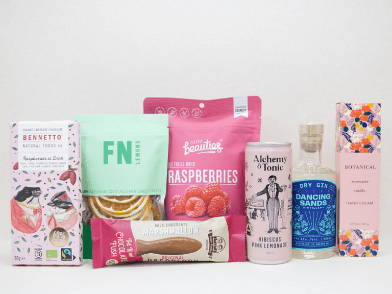 The Perfect G&T Gift Box featuring Dancing Sands Gin, Alchemy & Tonic Lemonade, Little Beauties freeze-dried raspberries, FN citrus garnishes, Botanicals Rosewater & Vanilla hand cream, Bennetto chocolate, and Potter Brothers chocolate fish, beautifully packaged for gin lovers and gifting.