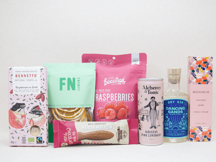 The Perfect G&T Gift Box featuring Dancing Sands Gin, Alchemy & Tonic Lemonade, Little Beauties freeze-dried raspberries, FN citrus garnishes, Botanicals Rosewater & Vanilla hand cream, Bennetto chocolate, and Potter Brothers chocolate fish, beautifully packaged for gin lovers and gifting.