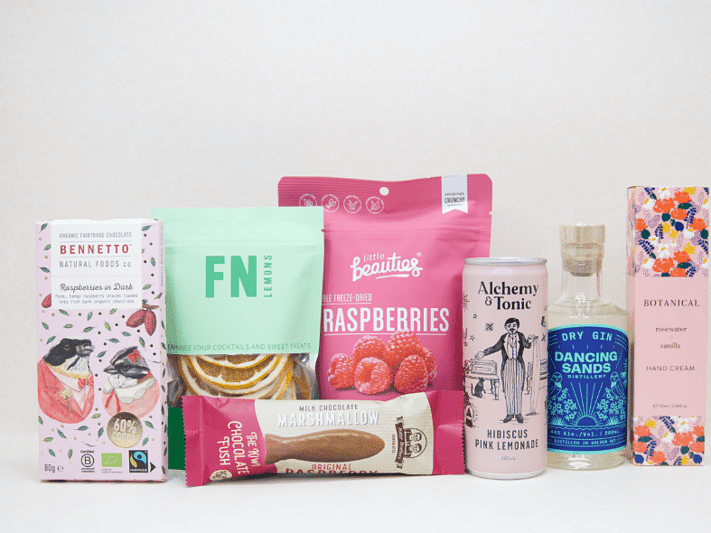 The Perfect G&T Gift Box featuring Dancing Sands Gin, Alchemy & Tonic Lemonade, Little Beauties freeze-dried raspberries, FN citrus garnishes, Botanicals Rosewater & Vanilla hand cream, Bennetto chocolate, and Potter Brothers chocolate fish, beautifully packaged for gin lovers and gifting.