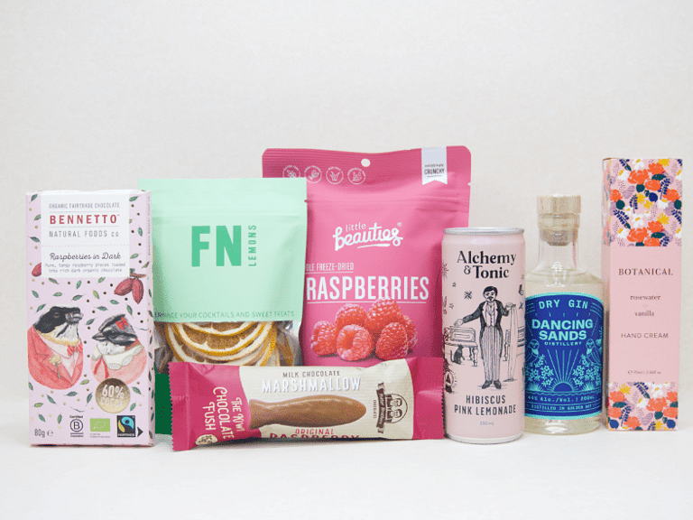 The Perfect G&T Gift Box featuring Dancing Sands Gin, Alchemy & Tonic Lemonade, Little Beauties freeze-dried raspberries, FN citrus garnishes, Botanicals Rosewater & Vanilla hand cream, Bennetto chocolate, and Potter Brothers chocolate fish, beautifully packaged for gin lovers and gifting.