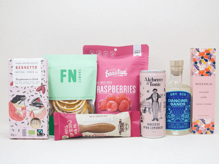 The Perfect G&T Gift Box featuring Dancing Sands Gin, Alchemy & Tonic Lemonade, Little Beauties freeze-dried raspberries, FN citrus garnishes, Botanicals Rosewater & Vanilla hand cream, Bennetto chocolate, and Potter Brothers chocolate fish, beautifully packaged for gin lovers and gifting.