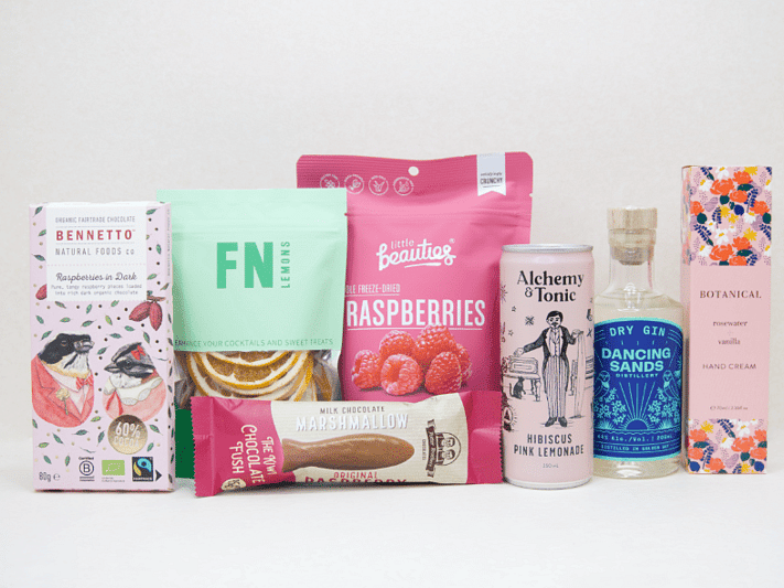 The Perfect G&T Gift Box featuring Dancing Sands Gin, Alchemy & Tonic Lemonade, Little Beauties freeze-dried raspberries, FN citrus garnishes, Botanicals Rosewater & Vanilla hand cream, Bennetto chocolate, and Potter Brothers chocolate fish, beautifully packaged for gin lovers and gifting.