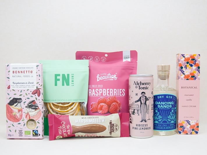 The Perfect G&T Gift Box featuring Dancing Sands Gin, Alchemy & Tonic Lemonade, Little Beauties freeze-dried raspberries, FN citrus garnishes, Botanicals Rosewater & Vanilla hand cream, Bennetto chocolate, and Potter Brothers chocolate fish, beautifully packaged for gin lovers and gifting.