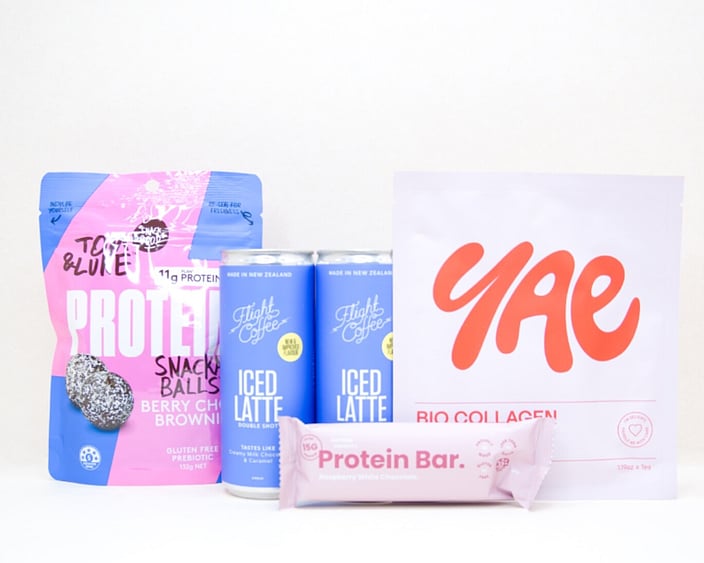 A Little Boost Gift Box featuring Flight Coffee cans, Tom & Luke protein bliss balls, Nothing Naughty protein bar, and a YAE face mask, beautifully packaged as an under $100 gift for coffee lovers and self-care gifting.