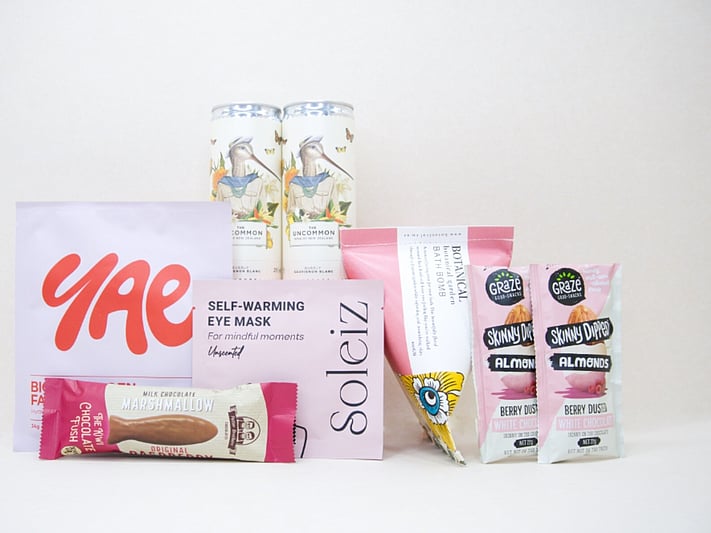 A Little Boost Gift Box featuring Flight Coffee cans, Tom & Luke protein bliss balls, Nothing Naughty protein bar, and a YAE face mask, beautifully packaged as an under $100 gift for coffee lovers and self-care gifting.