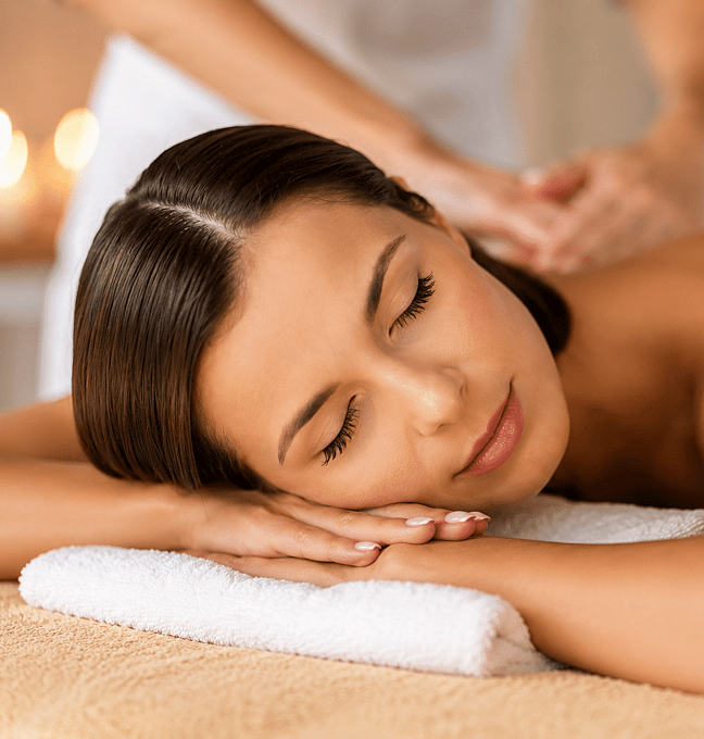 Picture of a lady lying on a massage bed having a back massage.