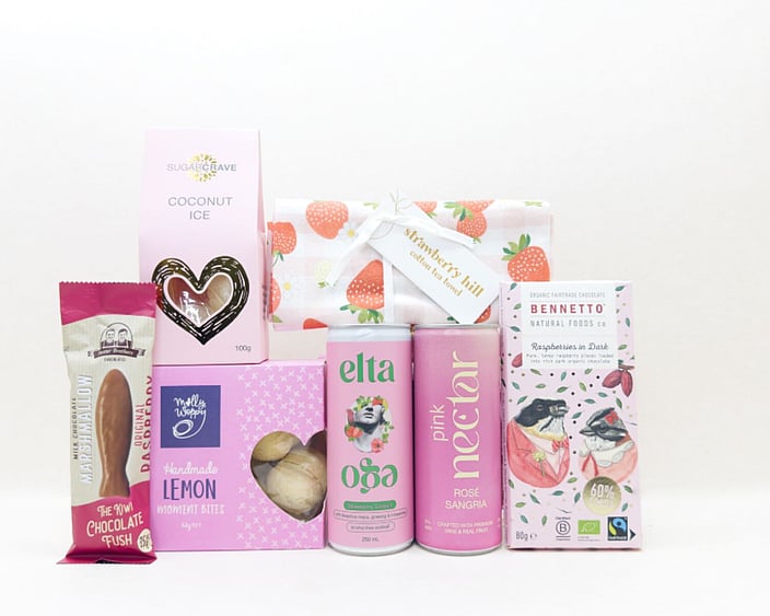 Pretty in Pink gift box with Nectar drink, Elta Ego products, Molly Woppy treats, Strawberry Hill tea towel, coconut ice, chocolate fish, and Bennetto chocolate, presented in a premium gift box