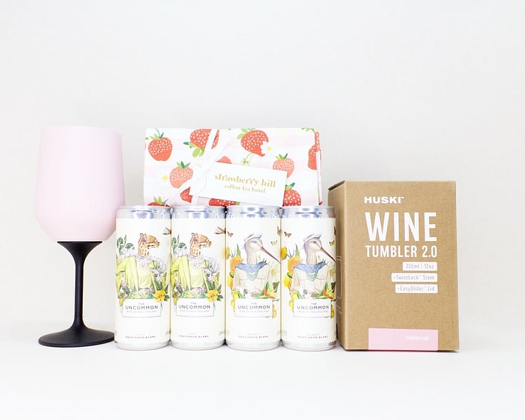 Let's Celebrate Gift Box featuring The Uncommon Sauvignon Blanc and Bubbly wine cans, a HUSKI wine tumbler or flute, and a Strawberry Hill tea towel, thoughtfully curated for birthdays, celebrations, thank you gifts, and life's special moments.