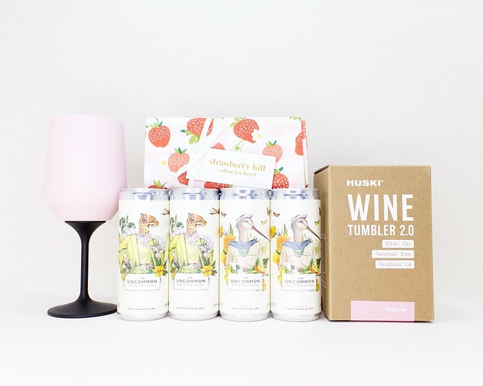 Pretty Wine Gift Box with four Uncommon wine cans, a HUSKI wine cooler, and a Strawberry Hill tea towel, thoughtfully presented in a premium gift box for relaxing, celebrating, and enjoying life's little moments