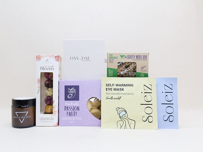 Mindful Moment self-care gift box with Soleiz eye masks, herbal tea balls, OAN DAE wish kit, Molly Woppy cookies, wellness products, and wholesome treats, designed to encourage rest, mindfulness, and everyday self-care