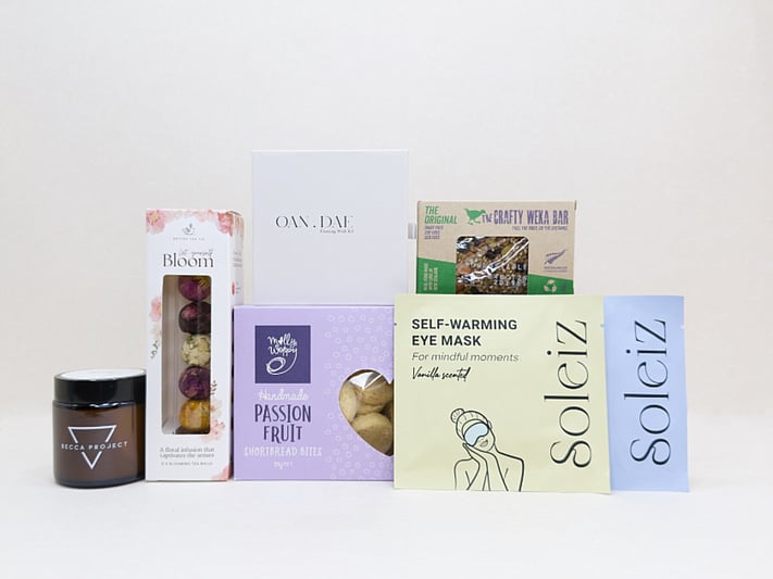 Mindful Moment self-care gift box with Soleiz eye masks, herbal tea balls, OAN DAE wish kit, Molly Woppy cookies, wellness products, and wholesome treats, designed to encourage rest, mindfulness, and everyday self-care