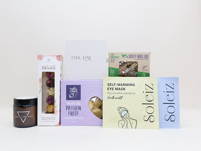 Mindful Moment self-care gift box with Soleiz eye masks, herbal tea balls, OAN DAE wish kit, Molly Woppy cookies, wellness products, and wholesome treats, designed to encourage rest, mindfulness, and everyday self-care