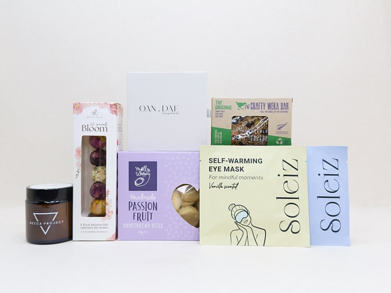 Mindful Moment self-care gift box with Soleiz eye masks, herbal tea balls, OAN DAE wish kit, Molly Woppy cookies, wellness products, and wholesome treats, designed to encourage rest, mindfulness, and everyday self-care