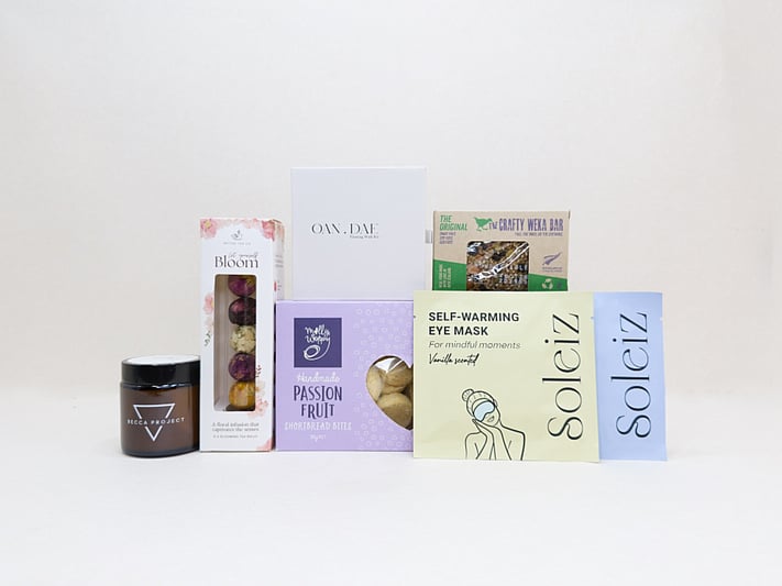 Mindful Moment self-care gift box with Soleiz eye masks, herbal tea balls, OAN DAE wish kit, Molly Woppy cookies, wellness products, and wholesome treats, designed to encourage rest, mindfulness, and everyday self-care