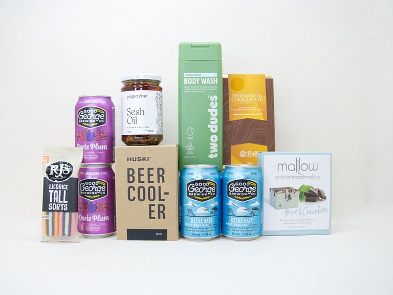 Spoil Him Gift Box featuring Good George beer, Two Dudes shower gel, Great Day Mallow treats, and a HUSKI beer cooler in a premium KYND gift box.