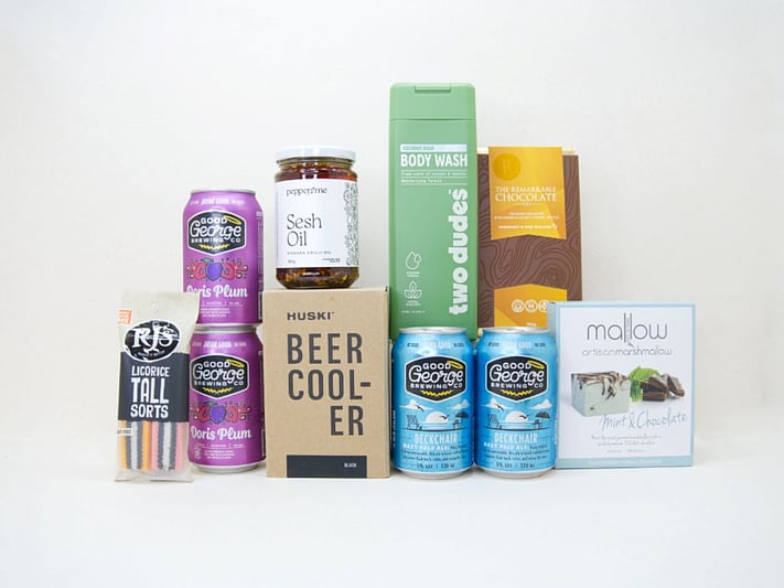 Spoil Him Gift Box featuring Good George beer, Two Dudes shower gel, Great Day Mallow treats, and a HUSKI beer cooler in a premium KYND gift box.