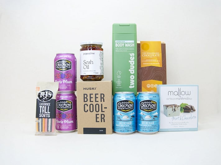 Spoil Him Gift Box featuring Good George beer, Two Dudes shower gel, Great Day Mallow treats, and a HUSKI beer cooler in a premium KYND gift box.