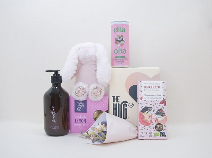 A Hug for Mum Gift Box featuring The HUG hot and cold gel pack, alcohol-free passionfruit cocktail, dried flowers, body wash, artisan chocolate, sweet treats, and a Lily & George teddy, beautifully presented in a premium KYND gift box.