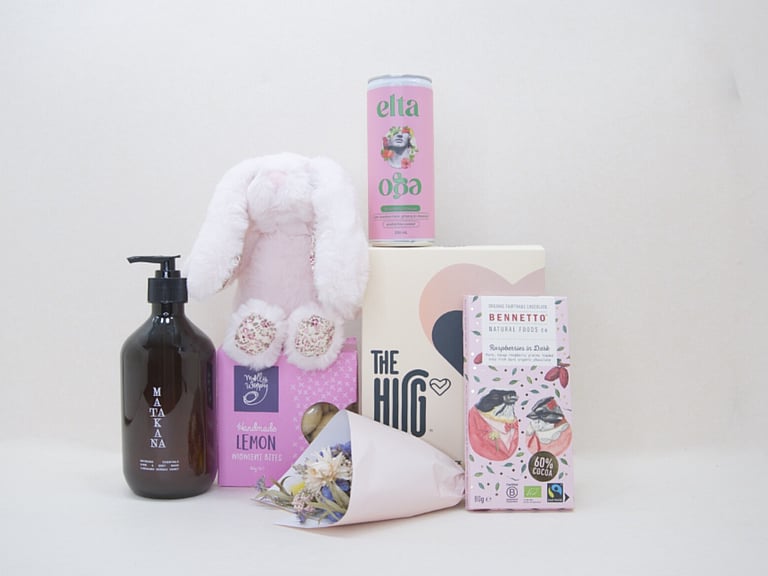 A Hug for Mum Gift Box featuring The HUG hot and cold gel pack, alcohol-free passionfruit cocktail, dried flowers, body wash, artisan chocolate, sweet treats, and a Lily & George teddy, beautifully presented in a premium KYND gift box.