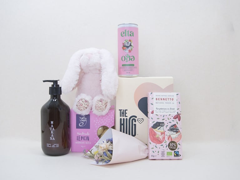 A Hug for Mum Gift Box featuring The HUG hot and cold gel pack, alcohol-free passionfruit cocktail, dried flowers, body wash, artisan chocolate, sweet treats, and a Lily & George teddy, beautifully presented in a premium KYND gift box.