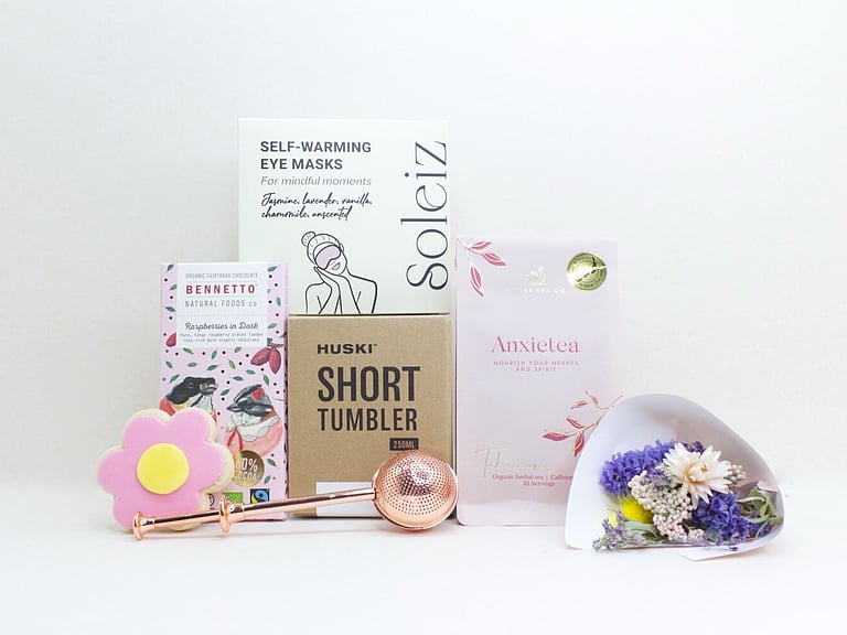 With Sympathy Gift Box with Deco by D dried flowers, Anxietea tea, Soleiz eye masks, Bennetto chocolate, and Molly Woppy cookies, thoughtfully presented as a comforting gift during difficult times.