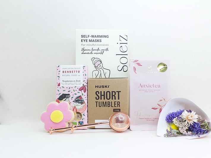 With Sympathy Gift Box with Deco by D dried flowers, Anxietea tea, Soleiz eye masks, Bennetto chocolate, and Molly Woppy cookies, thoughtfully presented as a comforting gift during difficult times.