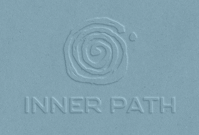 Inner Path logo design embossed into blue paper as an example of a standalone brand mark.