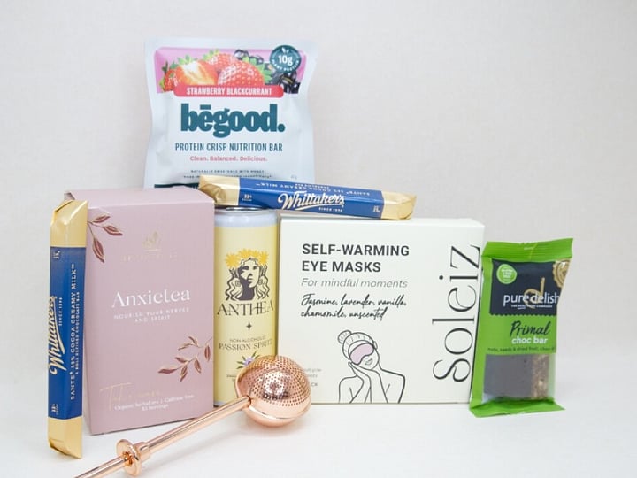 Take It Easy Gift Box featuring Better Tea Co Anxietea tea leaves, tea infuser strainer, Be Good protein bar, Whittaker's Sante bars, and Pure Delish chocolate, beautifully packaged as a calming self-care and wellness gift.