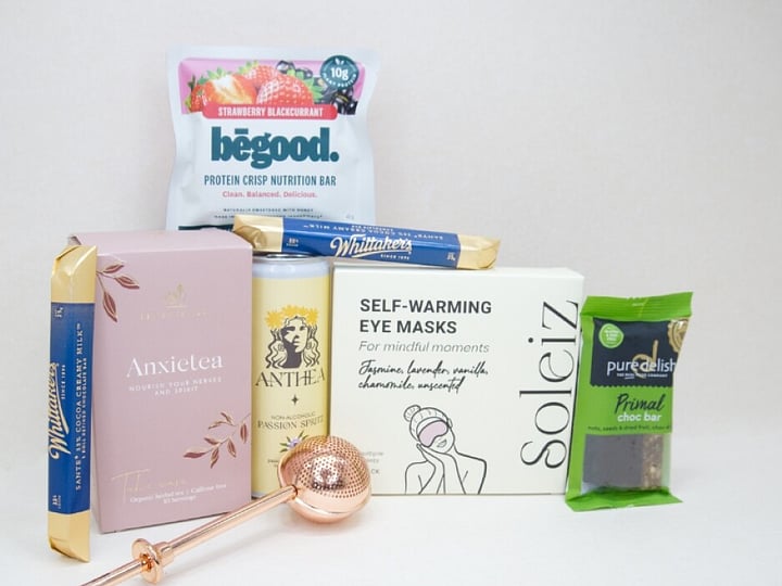 Take It Easy Gift Box featuring Better Tea Co Anxietea tea leaves, tea infuser strainer, Be Good protein bar, Whittaker's Sante bars, and Pure Delish chocolate, beautifully packaged as a calming self-care and wellness gift.