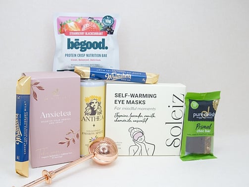 Take It Easy Gift Box featuring Better Tea Co Anxietea tea leaves, tea infuser strainer, Be Good protein bar, Whittaker's Sante bars, and Pure Delish chocolate, beautifully packaged as a calming self-care and wellness gift.