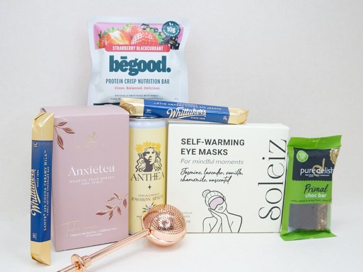 Take It Easy Gift Box featuring Better Tea Co Anxietea tea leaves, tea infuser strainer, Be Good protein bar, Whittaker's Sante bars, and Pure Delish chocolate, beautifully packaged as a calming self-care and wellness gift.