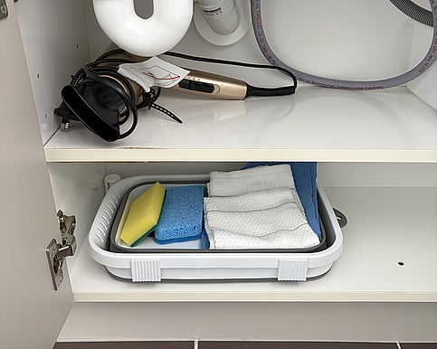 Picture of a a portable washing basin in side the cabinet of the vanity.
