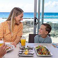 A family enjoying a meal at Currumbin Beach Vikings Surf Life Saving Club