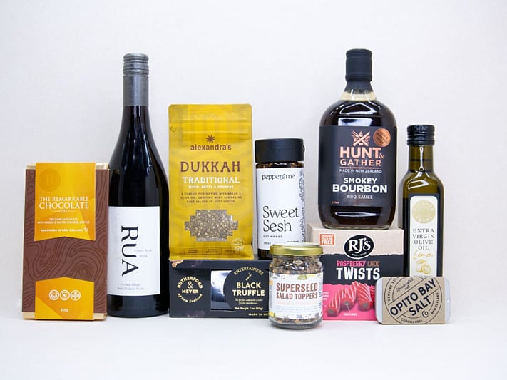 The Foodie gift box featuring Rua Pinot Noir, black truffle crackers, dukkah, lemon olive oil, hot honey, gourmet seasonings, artisan chocolate, caramel brittle, and premium New Zealand pantry favourites, beautifully packaged for food lovers and entertaining.