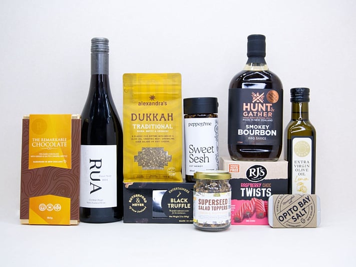The Foodie gift box featuring Rua Pinot Noir, black truffle crackers, dukkah, lemon olive oil, hot honey, gourmet seasonings, artisan chocolate, caramel brittle, and premium New Zealand pantry favourites, beautifully packaged for food lovers and entertaining.