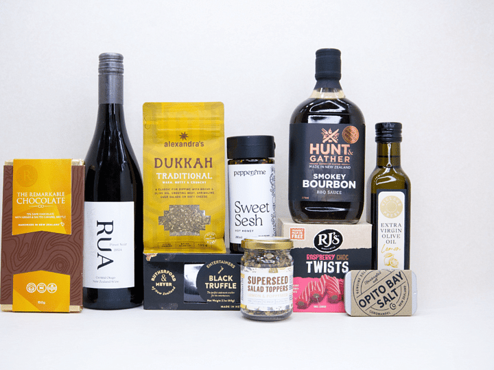 The Foodie gift box featuring Rua Pinot Noir, black truffle crackers, dukkah, lemon olive oil, hot honey, gourmet seasonings, artisan chocolate, caramel brittle, and premium New Zealand pantry favourites, beautifully packaged for food lovers and entertaining.