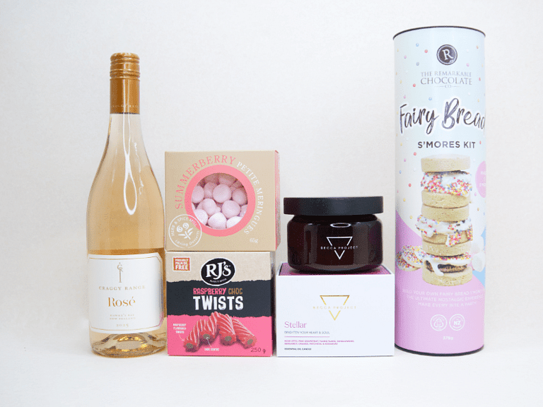 Birthday Girl gift box featuring Craggy Range Rosé, Becca Project candle, Remarkable S'mores chocolate, RJ's Raspberry Chocolate Twists, and strawberry petite meringues, beautifully packaged as a birthday gift box for her.