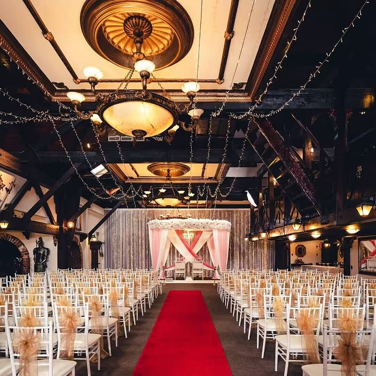 Indoor Hindu wedding ceremony with Mandap and guest seating at Settlers Country Manor Auckland