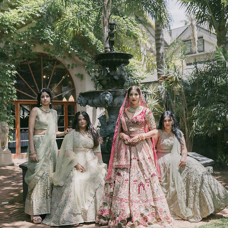 Indian bride with bridesmaids in the gardens at Settlers Country Manor