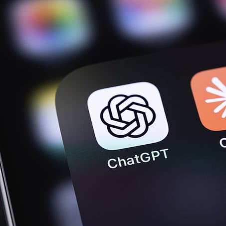 Close up of iphone screen with ChatGPT & Claude app icons