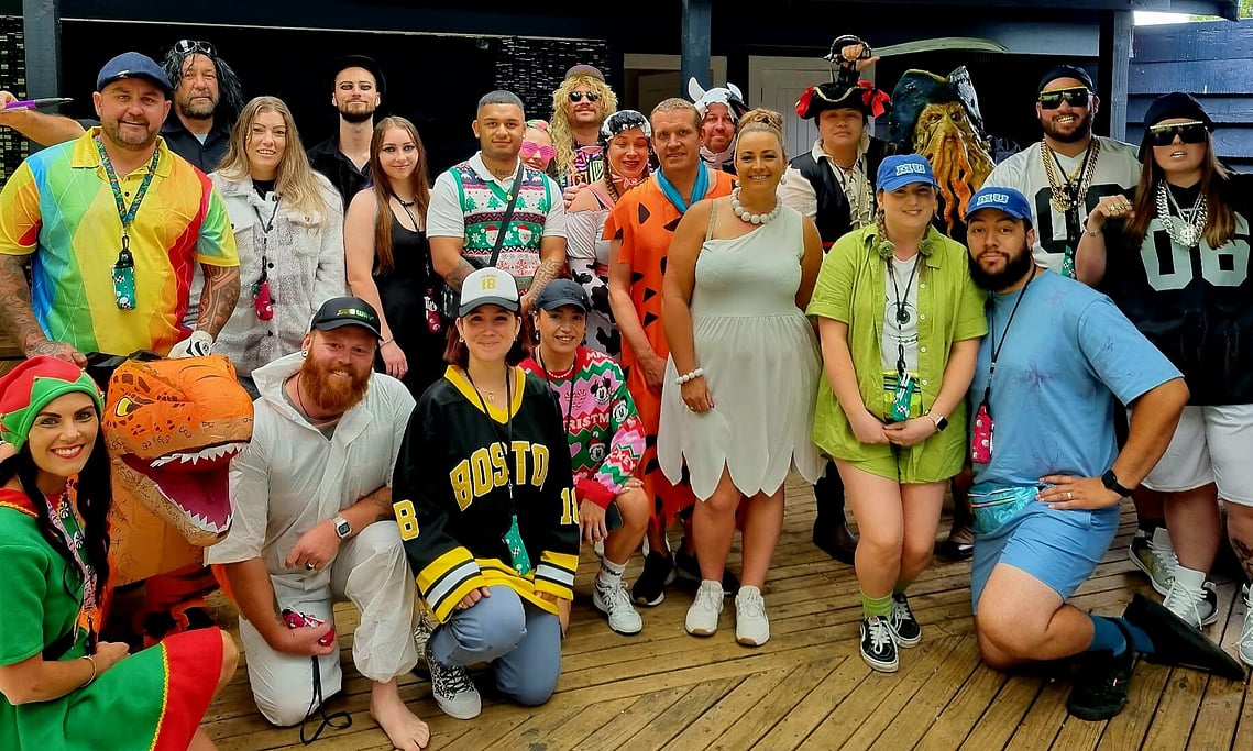 Group photo of the team and their families at The Glass Guys