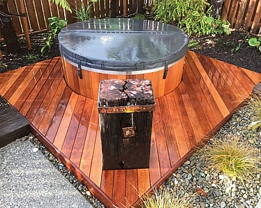 Finished timber spa deck integrated into a landscaped Nelson garden