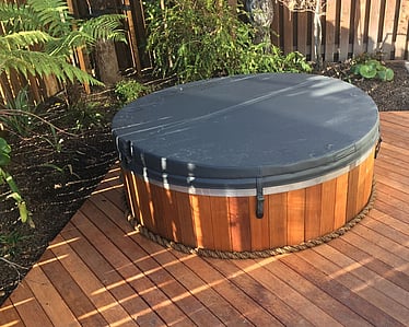 Custom timber decking fitted around an outdoor spa in Nelson