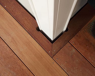 Mitred timber decking neatly finished around a deck post
