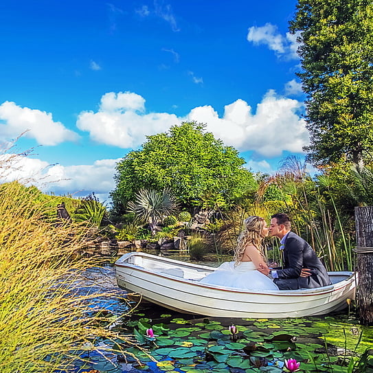 couple kissing on a rowboat