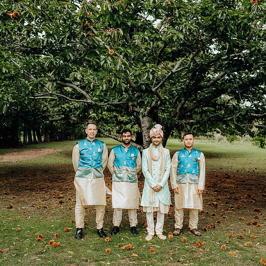 Groom and Groomsman infront of Chestnut Tree