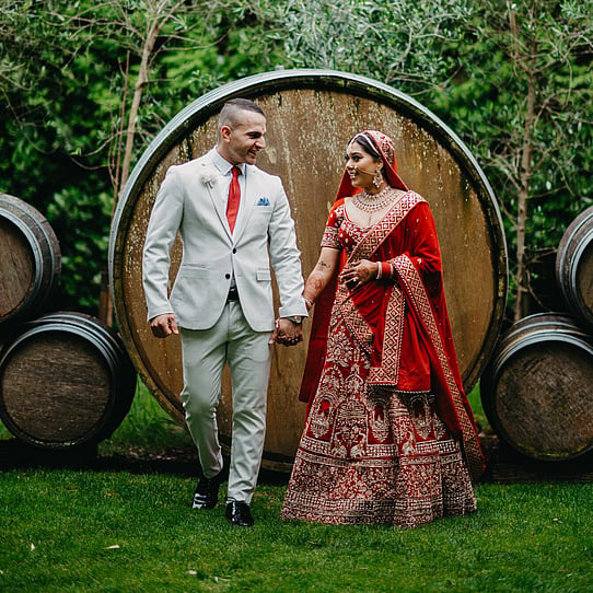 Bride and Groom infront of Barrel Feature